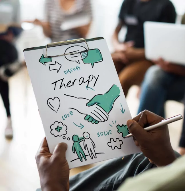 Patient holding a clipboard with therapy notes